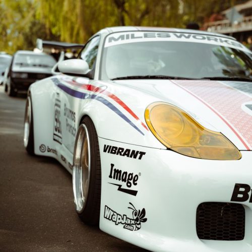 Close-up of a sleek racing car with vibrant decals at an auto show in Seattle, Washington.